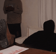 a person laying on a couch with their feet on a table with a piece of paper that says " i love you "