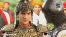 a man in armor is standing in front of a sony television ad