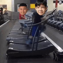 two young boys are running on a treadmill that says woodway