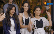 a group of women standing next to each other with a sctv logo behind them