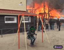a cartoon of a crocodile on a swing in front of a burning house