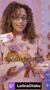 a woman with curly hair and glasses is holding a magic wand and says i 'm a magical girl