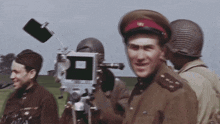 a man in a military uniform stands in front of a camera with a square on it