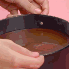 a close up of a person holding a bowl of liquid with easy plus written on the bottom of the image