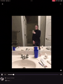 a video of a woman taking a selfie in a bathroom at 11:57 am