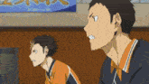 two anime characters are standing in front of a sign that says ' tokyo '