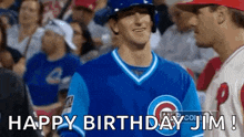 a baseball player in a blue jersey is standing in front of a crowd and says happy birthday jim !