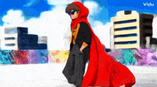 a man in a red cape is walking in front of buildings