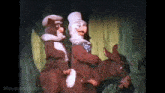 two cartoon characters riding on the back of a donkey