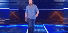 a man with a beard is walking on a stage in front of a sign that says daniel bryan .