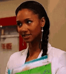 a woman in a white lab coat is holding a bag of food .