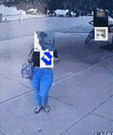a woman walking down a sidewalk with a blue arrow pointing right