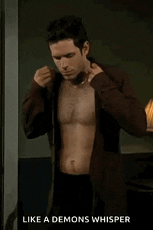 a shirtless man is standing in a room with the words `` like a demons whisper '' below him .