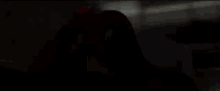 a close up of a person wearing a spiderman costume standing in a dark room .