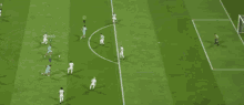 a soccer game is being played on a field with a yellow circle in the middle of the field