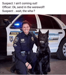 a police officer kneeling next to a black dog in front of a car that says town