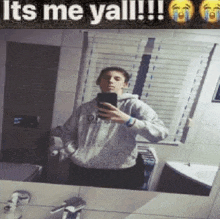 a man is taking a selfie in a bathroom mirror with a caption that says `` it 's me yall ! ''