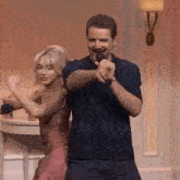 a man and a woman are dancing together on a stage .