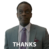 a man in a suit and tie has the word thanks written on his chest