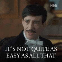 a man in a tuxedo with a mustache says it 's not quite as easy as all that