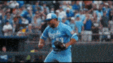 a baseball player wearing a blue royals jersey is throwing a ball