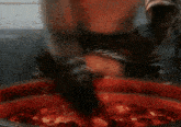 a person is standing in front of a fire with sparks flying around them