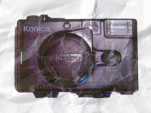 a picture of a konica camera on crumpled paper