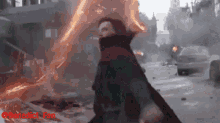 a man in a cloak is standing in front of a fire and the words benedict fan are visible