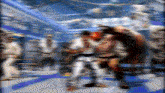 a blurry picture of a karate match between two fighters