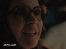 a close up of a woman wearing glasses with the hashtag lialmeida05 below her