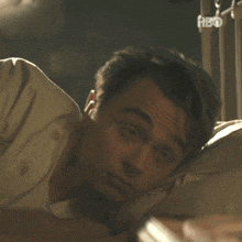a man laying on a bed with hbo written on the bottom right