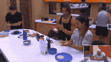 a group of people sitting around a table with plates and bowls on it