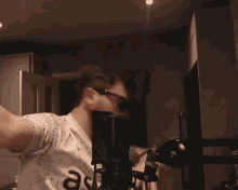 a man wearing sunglasses and a shirt that says ast