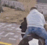 a man is riding a horse in a park while a woman watches .