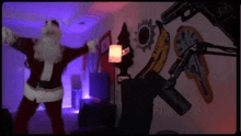 a man dressed as santa claus is dancing in front of a microphone in a dark room