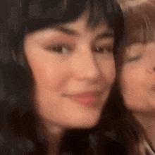 a close up of a woman 's face with another woman 's face behind her .