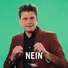 a man in a red jacket is making a fist with the word nein above him