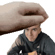 a hand is holding a man 's head in a pixel art .