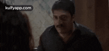 a man is talking to another man and the man is asking if the woman is irritating him .