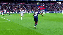 a soccer player wearing a number 10 jersey kicks a ball