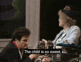 a woman in a wheelchair is being comforted by a man in a suit