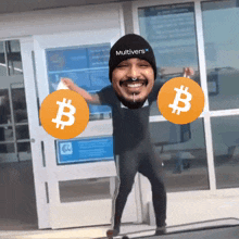a man wearing a hat that says multiverse on it is holding two bitcoins