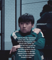a man in a green jacket is sitting with his arm around his shoulder