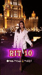 a woman in a white coat stands in front of a building with rit 10 written on it