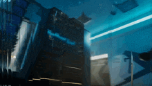a dark room with a blue light shining through the windows