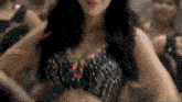 a woman in a crop top is dancing in front of a crowd with the words loser on the bottom right
