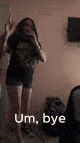 a girl dancing in a room with the words um bye written on the bottom