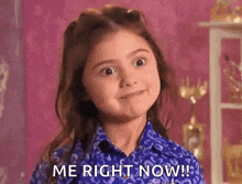 a little girl in a blue shirt is making a face and saying `` me right now '' .