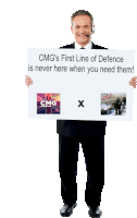 a man in a suit holding a sign that says cmg 's first line of defence is never here when you need them