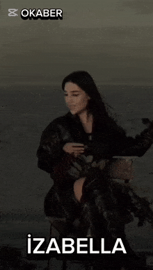 a woman is sitting in a chair with the name izabella on the top